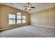 Bright bedroom featuring carpet, ceiling fan and two arched windows at 629 Swinford Dr., Myrtle Beach, SC 29588