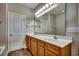 Double vanity bathroom with a large mirror and tiled floor at 629 Swinford Dr., Myrtle Beach, SC 29588
