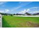 Large grassy backyard with a white fence and distant homes at 629 Swinford Dr., Myrtle Beach, SC 29588