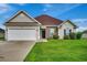 House exterior showcasing a two-car garage and well-maintained lawn at 629 Swinford Dr., Myrtle Beach, SC 29588