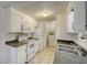 Efficient kitchen featuring white cabinets, built-in microwave, and an electric range at 1119 Blue Ridge Trail, North Myrtle Beach, SC 29582