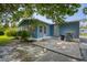 Blue house exterior with a patio, landscaping, and a spacious backyard at 1119 Blue Ridge Trail, North Myrtle Beach, SC 29582