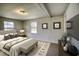 Cozy bedroom with a queen bed, bench, and neutral decor at 1119 Blue Ridge Trail, North Myrtle Beach, SC 29582
