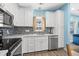 Modern kitchen with white cabinets, stainless appliances, and mosaic backsplash at 6001-1573 S Kings Hwy., Myrtle Beach, SC 29575