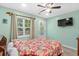 Bedroom with a floral comforter, TV, and access to a deck at 6001-1573 S Kings Hwy., Myrtle Beach, SC 29575