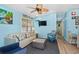 Bright living room with comfy seating, large TV, and ceiling fan at 6001-1573 S Kings Hwy., Myrtle Beach, SC 29575