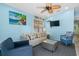 Bright living room with comfy seating, large TV, and ceiling fan at 6001-1573 S Kings Hwy., Myrtle Beach, SC 29575