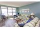 Living room with ocean view and comfortable striped sofa at 523 S Ocean Blvd. S, North Myrtle Beach, SC 29582