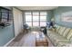 Living room boasts ocean view, comfortable seating, and large TV at 523 S Ocean Blvd. S, North Myrtle Beach, SC 29582