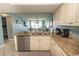 Kitchen with granite countertops, stainless steel appliances, and view to living area at 523 S Ocean Blvd. S, North Myrtle Beach, SC 29582