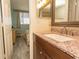 Bathroom with granite vanity and view of bedroom at 523 S Ocean Blvd. S, North Myrtle Beach, SC 29582