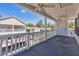 Spacious deck with white railings and ceiling fans, offering relaxing views at 6001 S Kings Hwy., Myrtle Beach, SC 29575