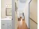Long hallway with light wood floors, leading to various rooms at 6001 S Kings Hwy., Myrtle Beach, SC 29575