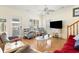 Cozy living room featuring hardwood floors, comfy seating, and a large TV at 6001 S Kings Hwy., Myrtle Beach, SC 29575