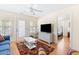 Spacious living area with white wicker furniture and hardwood floors at 6001 S Kings Hwy., Myrtle Beach, SC 29575