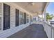 Deck with white railings, gray flooring, and ceiling fans at 6001 S Kings Hwy., Myrtle Beach, SC 29575