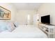 Bright bedroom with a queen bed, TV, and en-suite bathroom at 6001 S Kings Hwy., Myrtle Beach, SC 29575