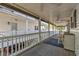 Long deck with white railings, gray flooring, and ceiling fans at 6001 S Kings Hwy., Myrtle Beach, SC 29575