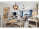 Open concept dining room with a large chandelier and view of living room at 5801 Oyster Catcher Dr. # 432, North Myrtle Beach, SC 29582