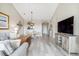 Bright living room with hardwood floors, comfy seating, and a large TV at 5801 Oyster Catcher Dr. # 432, North Myrtle Beach, SC 29582
