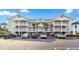 Three-story building exterior with parking in front at 5801 Oyster Catcher Dr. # 432, North Myrtle Beach, SC 29582