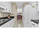 Kitchen with white cabinets, dark countertops, and a view into the dining area at 210 Maison Dr. # K 202, Myrtle Beach, SC 29572