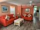 Living room with two orange couches and a coffee table at 329 54Th Ave. N, North Myrtle Beach, SC 29582