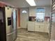 White kitchen with stainless steel appliances and light wood floors at 329 54Th Ave. N, North Myrtle Beach, SC 29582