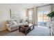 Bright living room featuring a comfy sofa and access to a patio at 115 Talladega Dr. # 405, Myrtle Beach, SC 29579