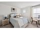 Cozy bedroom with a striped comforter and a bedside table at 115 Talladega Dr. # 405, Myrtle Beach, SC 29579