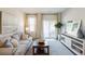 Living room with white media console, sliding glass doors and backyard view at 115 Talladega Dr. # 405, Myrtle Beach, SC 29579