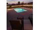 Relaxing backyard pool at night with string lights and lounge chairs at 1459 Tiger Grand Dr., Conway, SC 29526