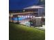 Backyard pool at night, illuminated with string lights, and patio furniture at 1459 Tiger Grand Dr., Conway, SC 29526