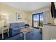 Living room with ocean view, sofa, and TV at 7100 Ocean Blvd. N # 925, Myrtle Beach, SC 29572
