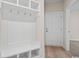 Built-in bench with storage and hooks in a white mudroom at 284 Starlit Way, Myrtle Beach, SC 29579