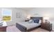 Serene bedroom with dark wood bed frame and ocean theme at 192 Hadley Springs Ave, Longs, SC 29568