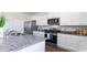 White kitchen with granite island, stainless steel appliances, and hardwood floors at 192 Hadley Springs Ave, Longs, SC 29568
