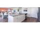 Open kitchen with white cabinets, granite island, and stainless steel appliances at 192 Hadley Springs Ave, Longs, SC 29568