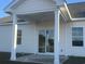 Covered patio with ceiling fan and sliding glass doors at 2323 King Farm Rd., Aynor, SC 29511