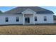 House exterior showcasing a back patio and lawn at 2323 King Farm Rd., Aynor, SC 29511