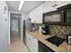 Small galley kitchen with granite counters and stainless steel appliances at 201 74Th Ave. N # 2829, Myrtle Beach, SC 29572