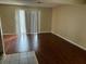 Living room showcasing dark wood laminate flooring and sliding glass doors at 1025 Carolina Rd. # G-3, Conway, SC 29526