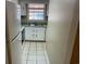 Galley kitchen featuring white cabinets and a double sink at 1025 Carolina Rd. # G-3, Conway, SC 29526