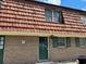 Brick building exterior with a charming green door and unique roofline at 1025 Carolina Rd. # G-3, Conway, SC 29526