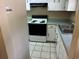 Efficient kitchen with white cabinets, electric range, and double sink at 1025 Carolina Rd. # G-3, Conway, SC 29526