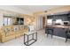 Open living room and kitchen with tile floors, comfy sofa, and ocean view at 1605 S Ocean Blvd. # 1104, Myrtle Beach, SC 29577