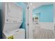 Stackable washer and dryer in a light blue laundry room at 6001-N37 S Kings Hwy., Myrtle Beach, SC 29575