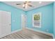 Bright bedroom with light blue walls, ceiling fan, and white doors at 6001-N37 S Kings Hwy., Myrtle Beach, SC 29575