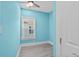 Small bedroom with light blue walls, wood-look floors, and a window at 6001-N37 S Kings Hwy., Myrtle Beach, SC 29575