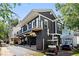 Two-story dark gray house with white trim, elevated foundation, and balcony at 6001-N37 S Kings Hwy., Myrtle Beach, SC 29575